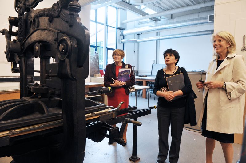 Examiners looking at an old press.