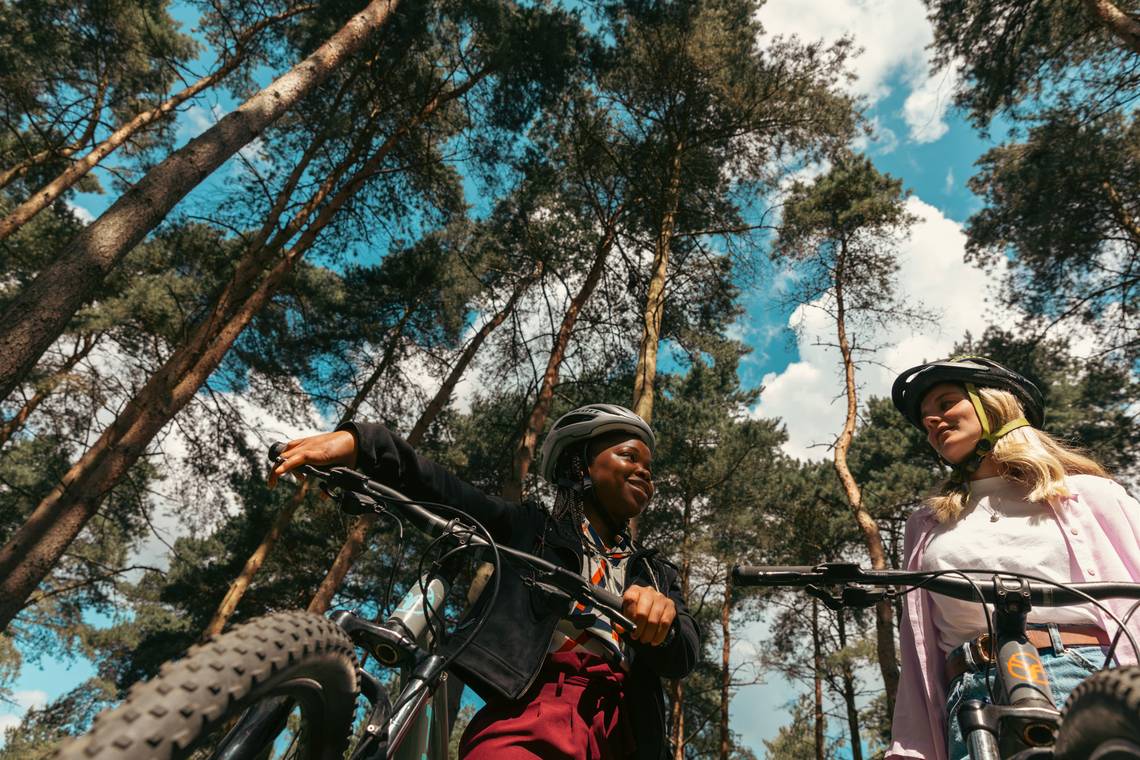 Students cycling in the woods