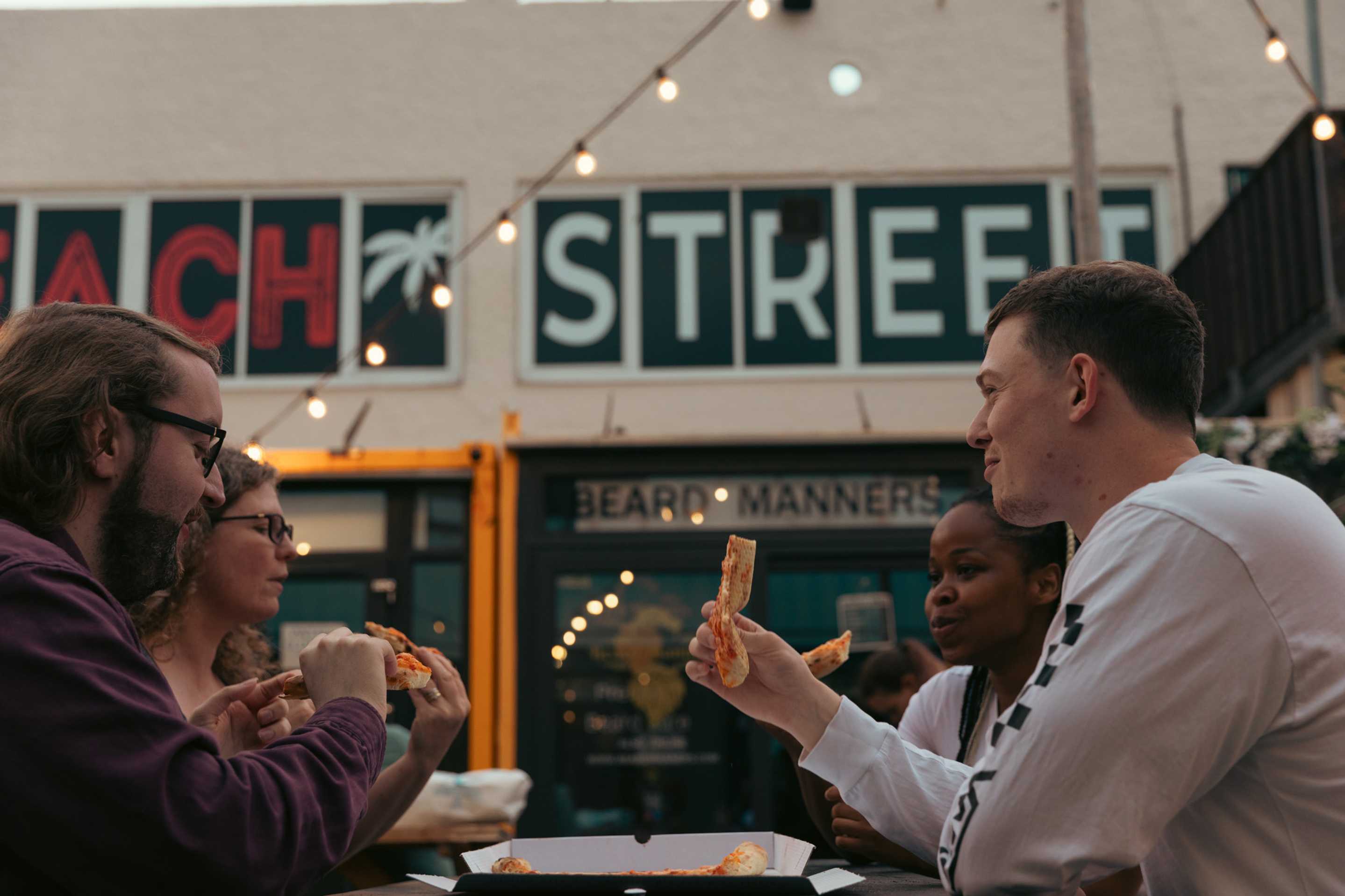 Students sharing a pizza at Beach Street, Felixstowe