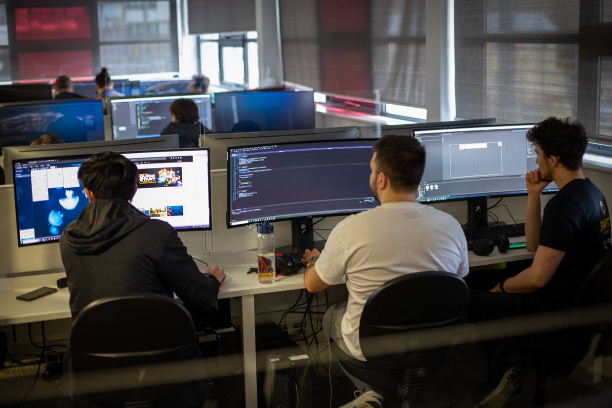 Three students gaming in classroom