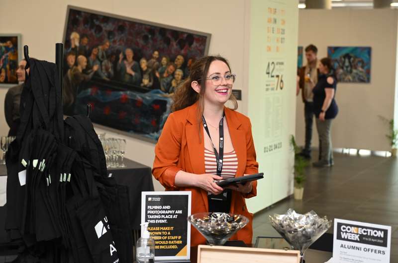 Staff member at an Alumni connection week stall
