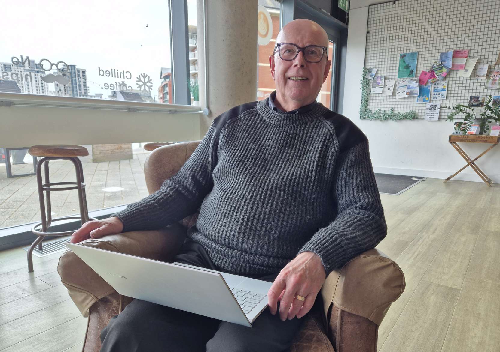Student with laptop in cafe setting