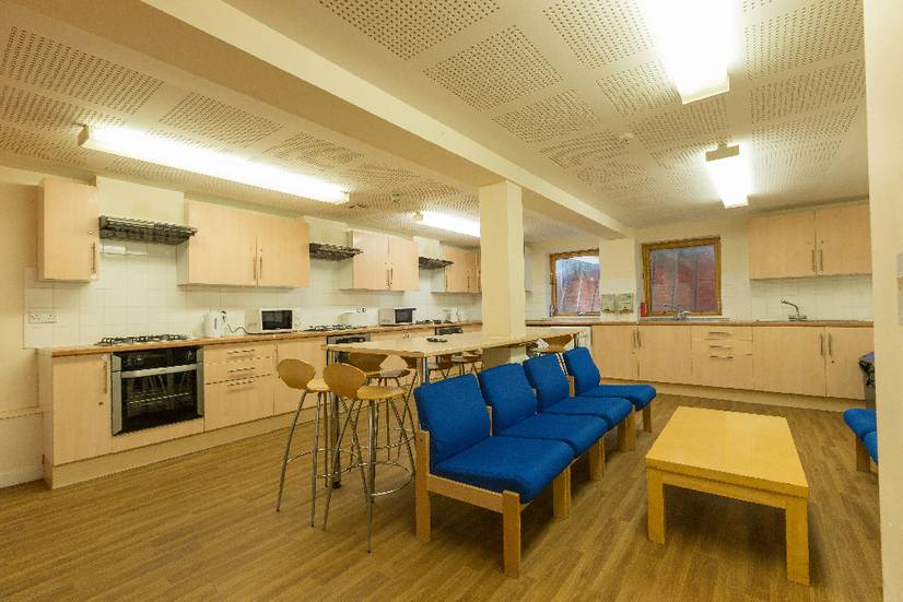 A large student kitchen with social seating area