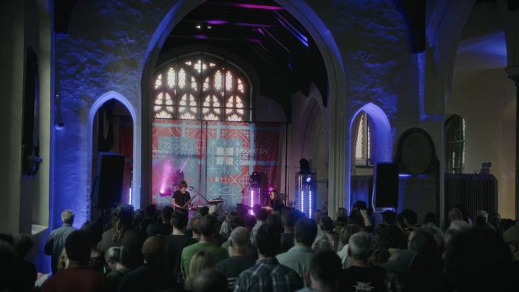 Crowd gathered listening to a band