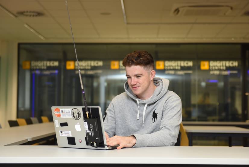 A student sitting with a laptop