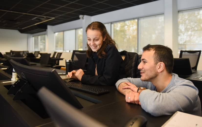 Two students working at a computer