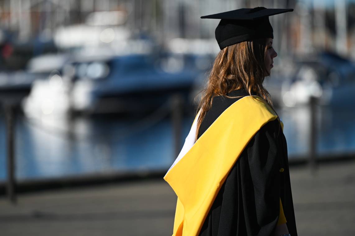 The back of a student in their cap and gown