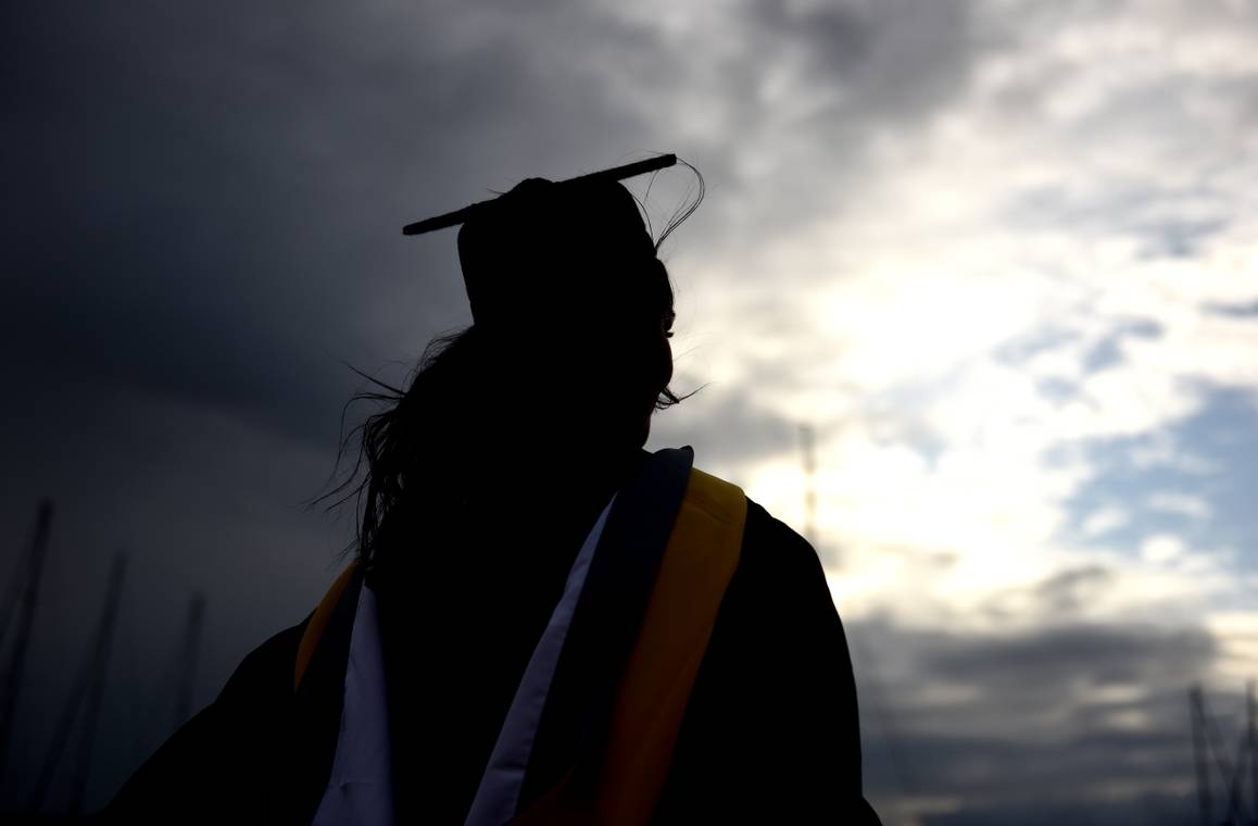 The back of a student in their cap and gown
