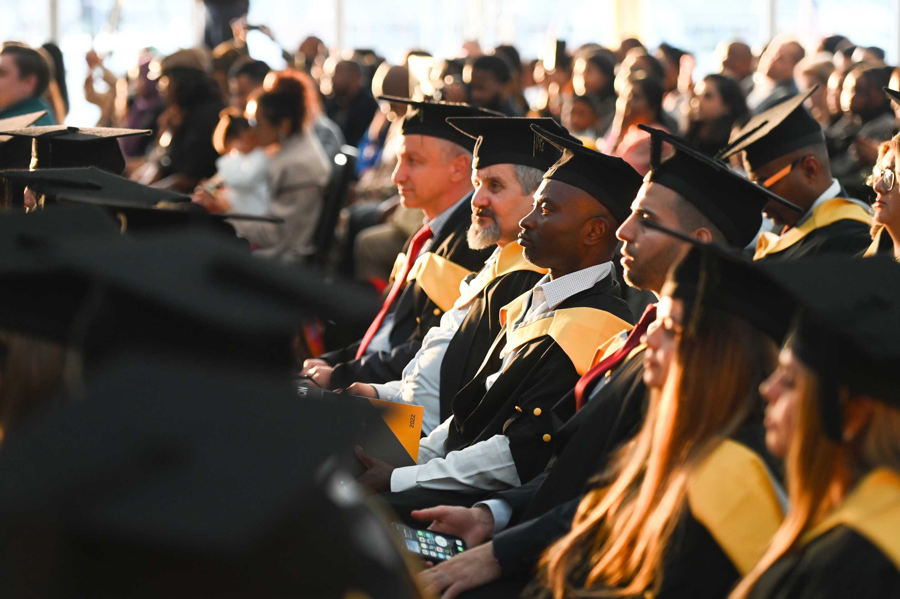 A row of students sitting in a graduation ceremony