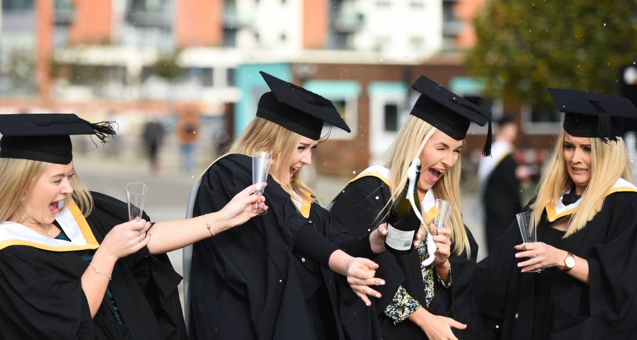 Students celebrating with glasses of champagne