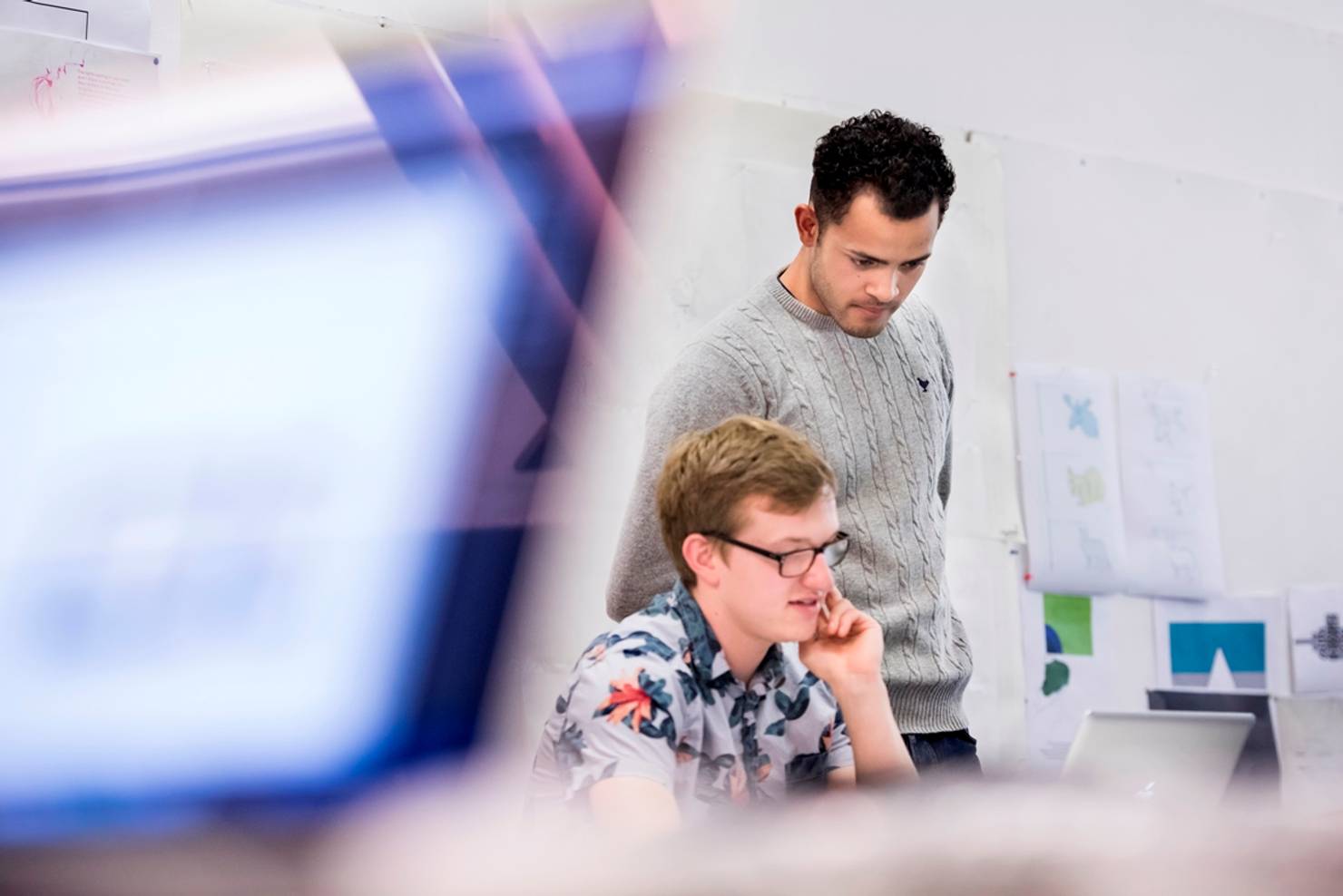 Two students reviewing work