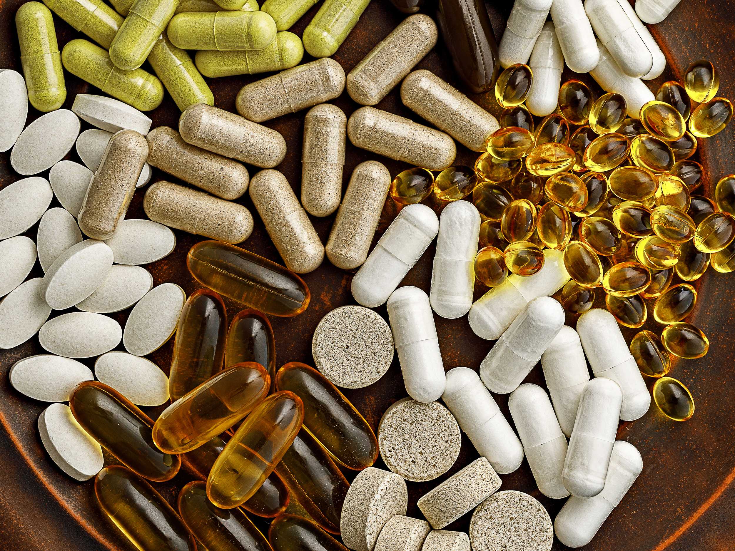 Multivitamin dietary supplements on a clay plate