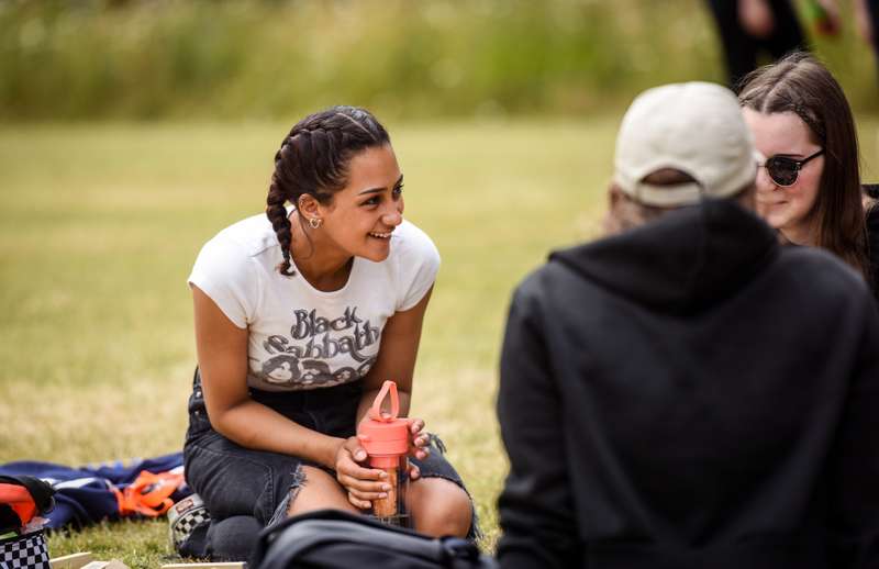 Students sitting, relaxing in a park