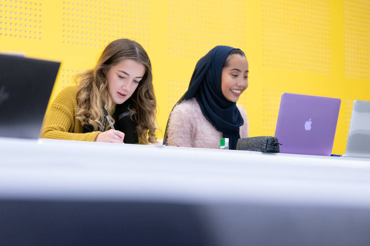 Two students sitting in a lecture