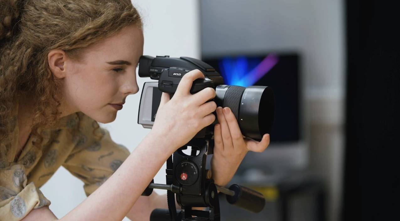 Close-up of student look through a camera