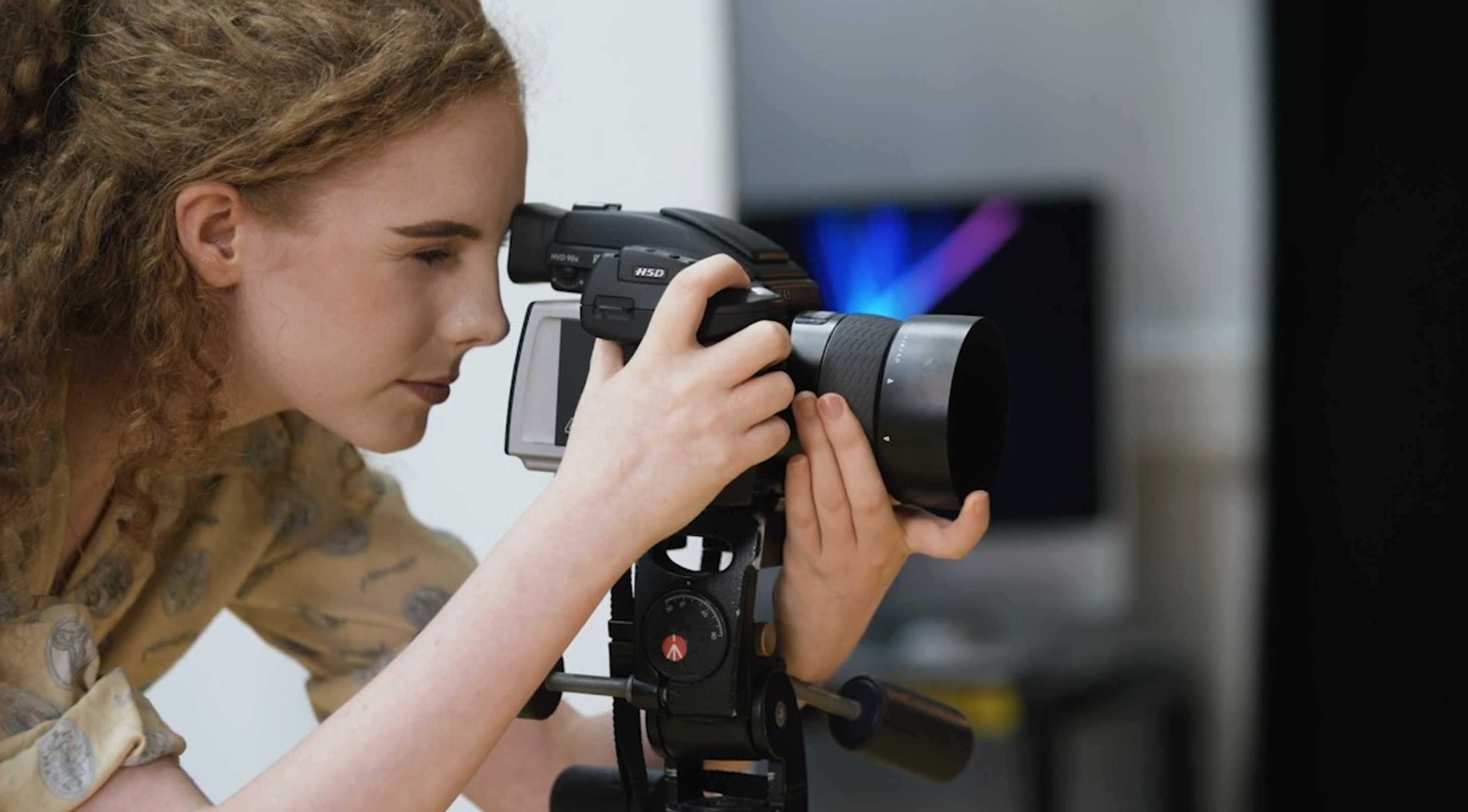 Close-up of student look through a camera