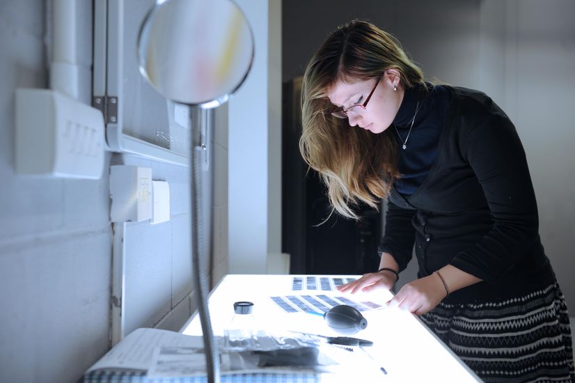 A student looking at negatives
