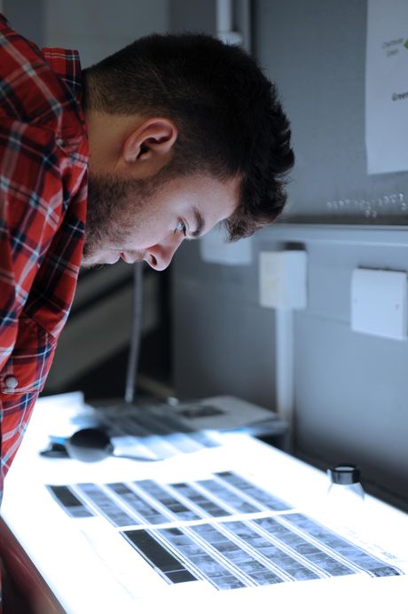 Close-up of student looking at negatives