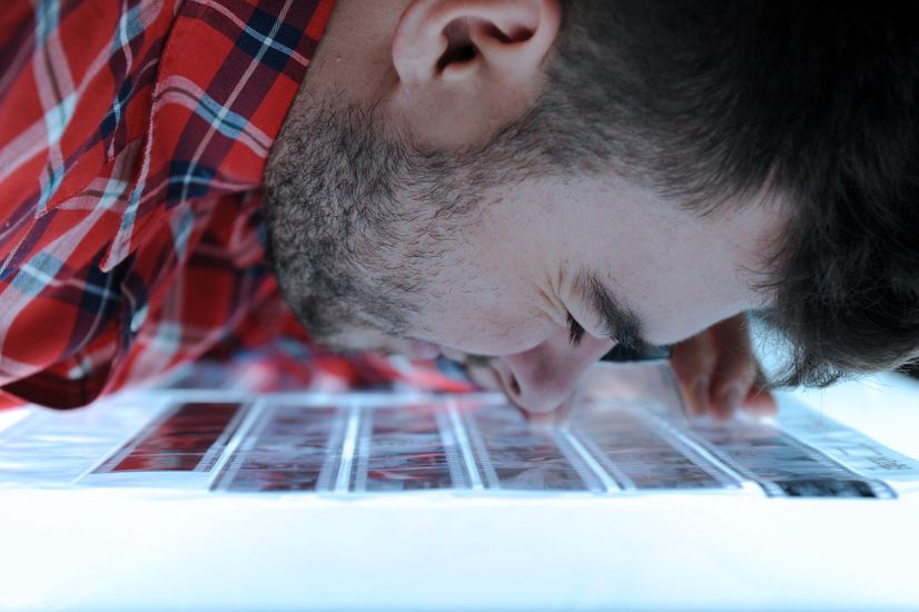Close-up of student viewing negatives