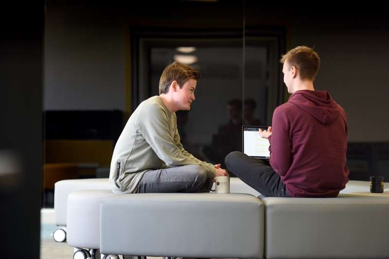 Two students sitting in the Ideas room