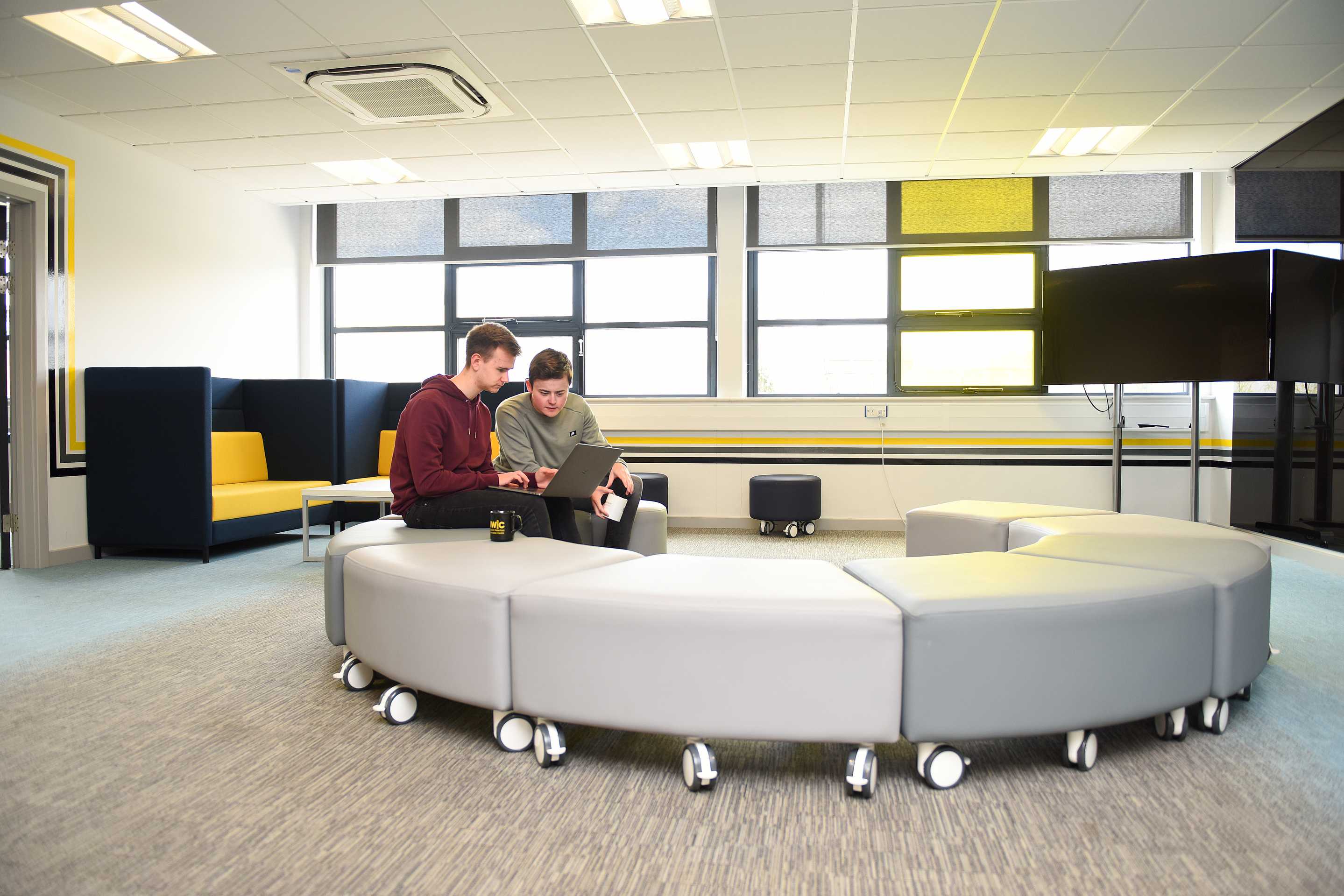 Two students sitting in the Ideas room