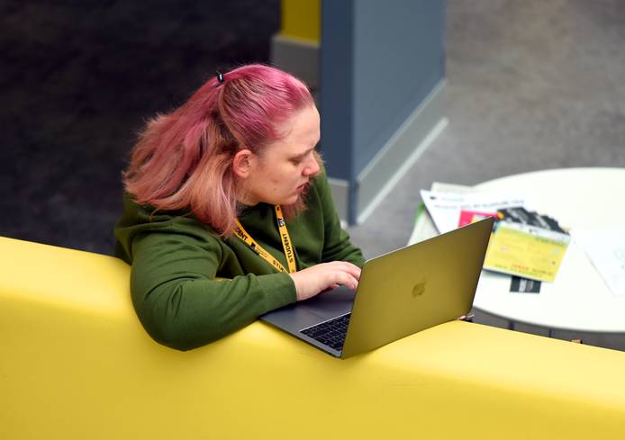 A student sitting with a laptop