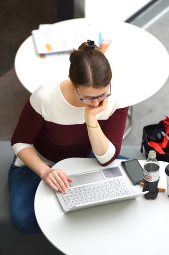 A student sitting and working on a laptop