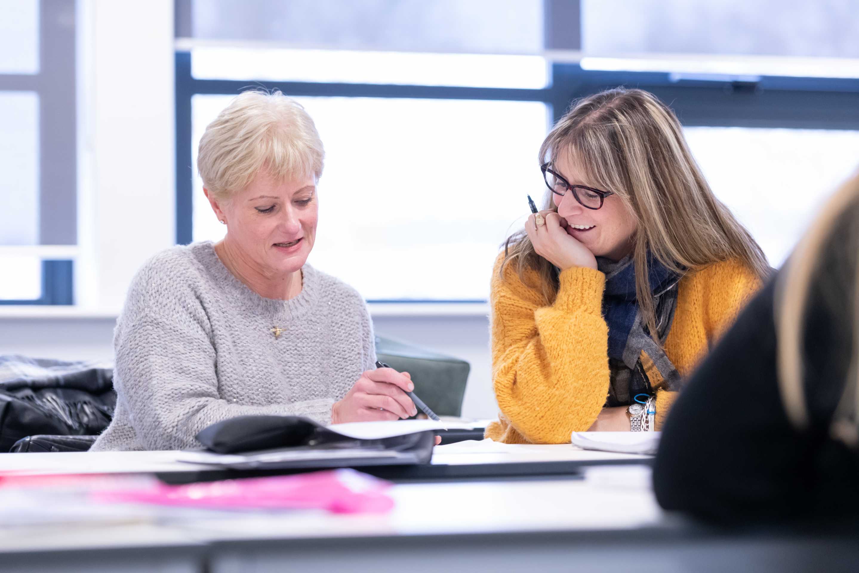 Two students discussing their work