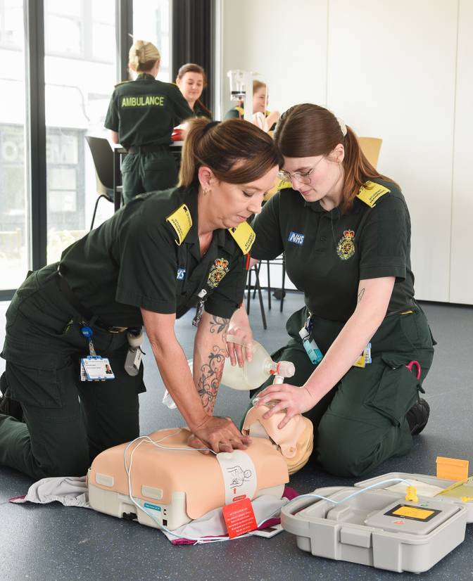 Two students practicing CPR