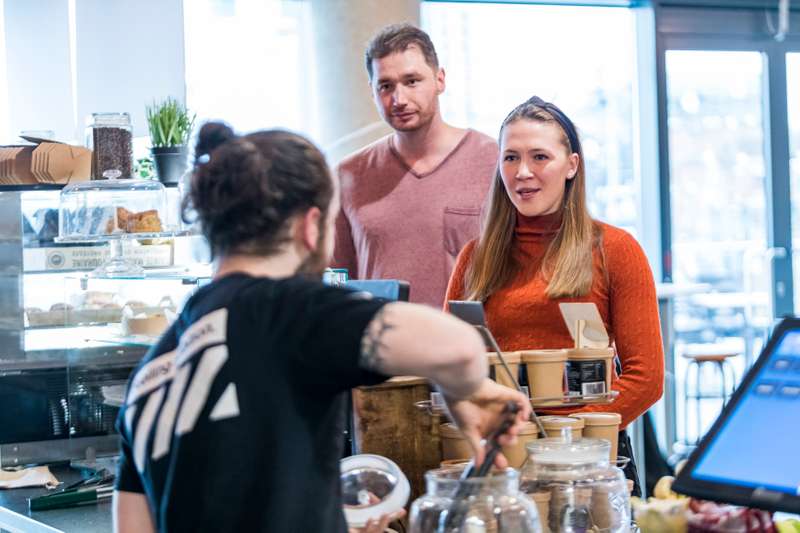 Students queuing at a counter in cafe