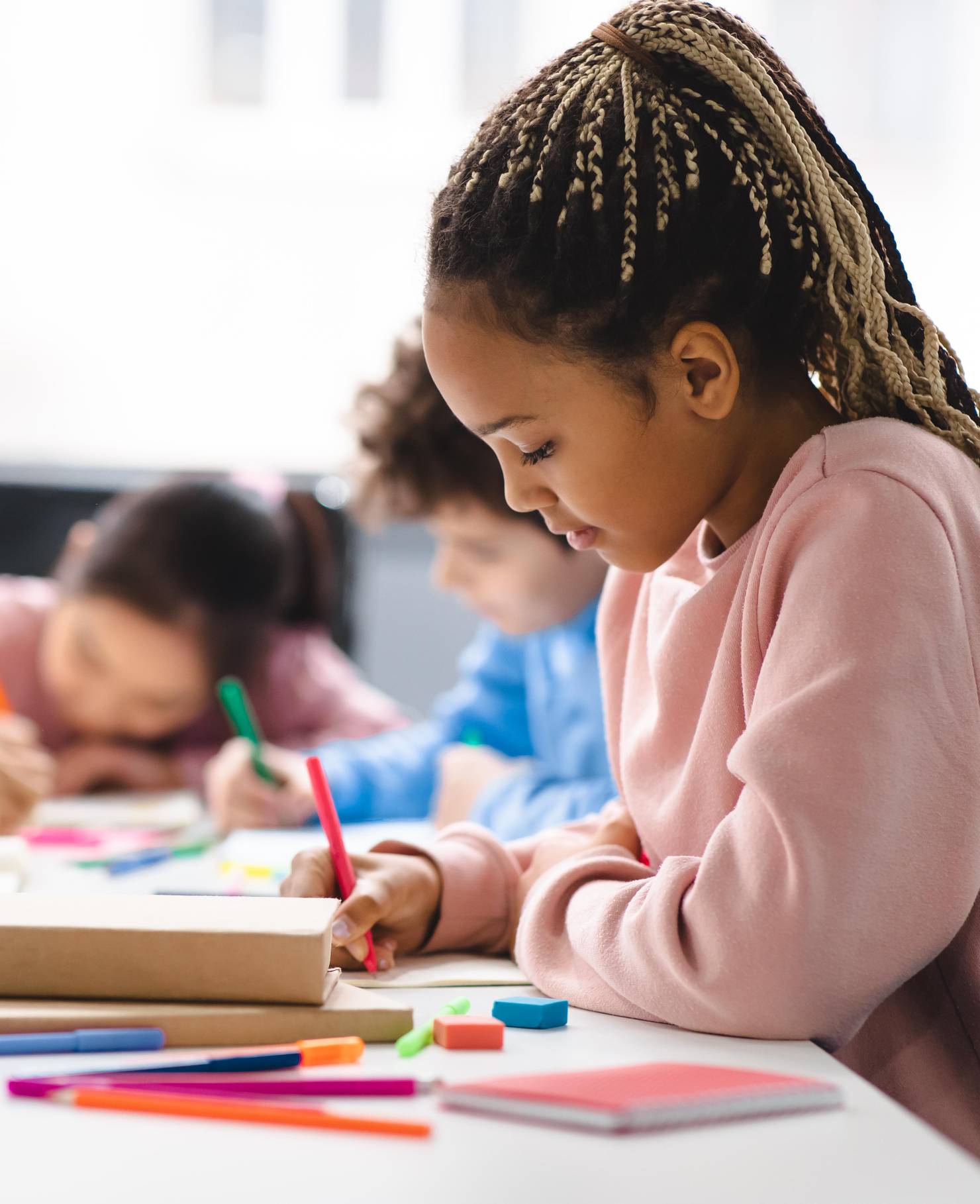 A child sitting and working in a classroom