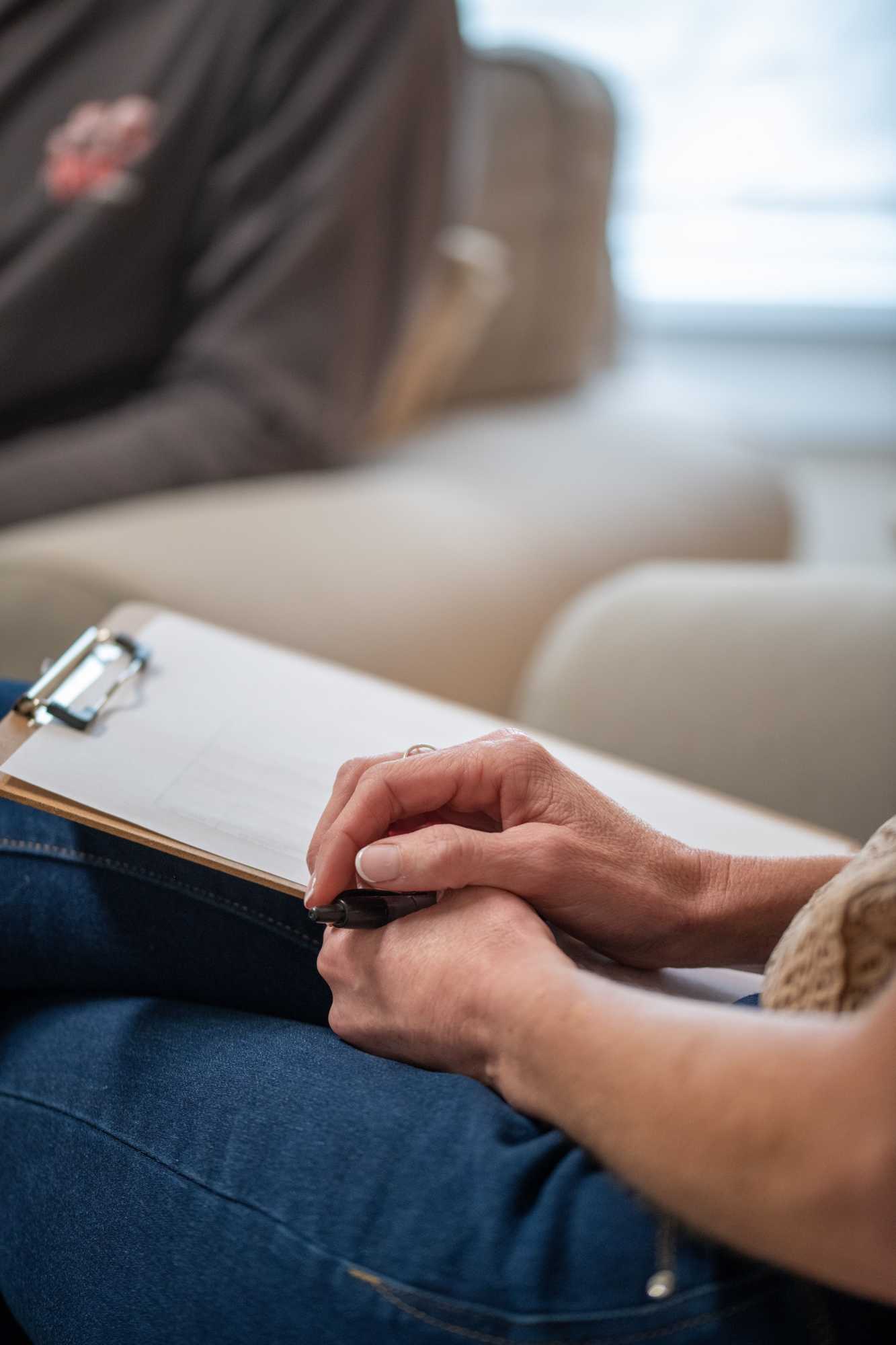 Close-up of a clipboard on someone lap