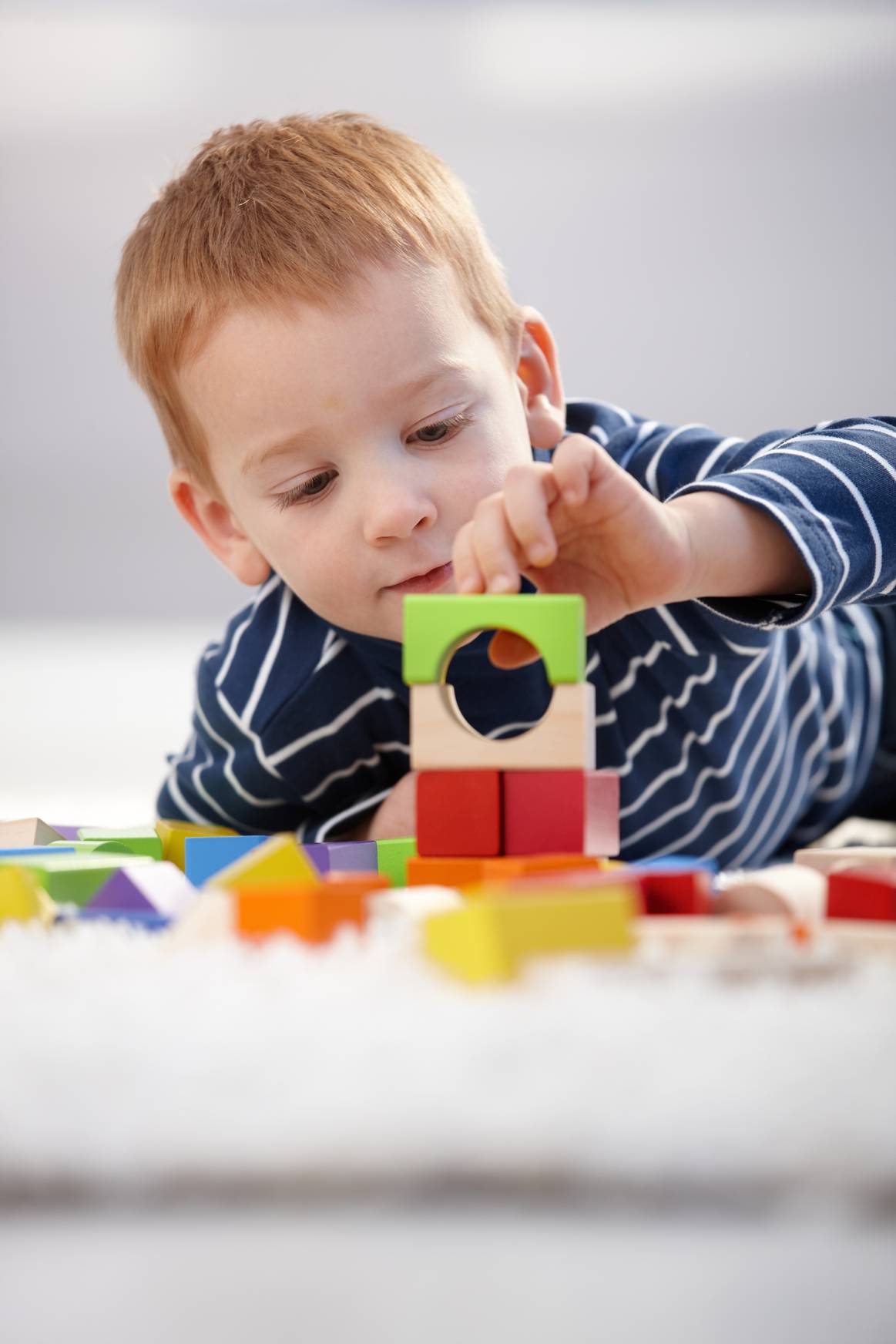 Toddler playing with wooden blocks
