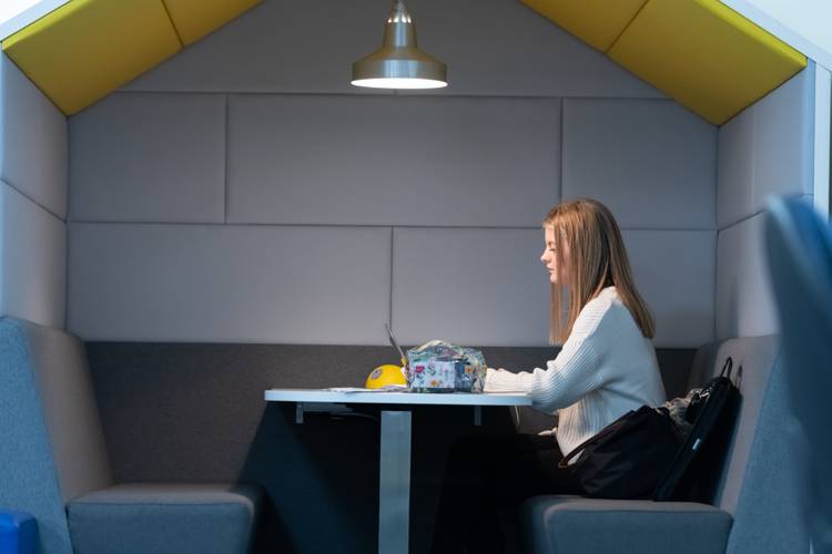 A student sitting with a laptop