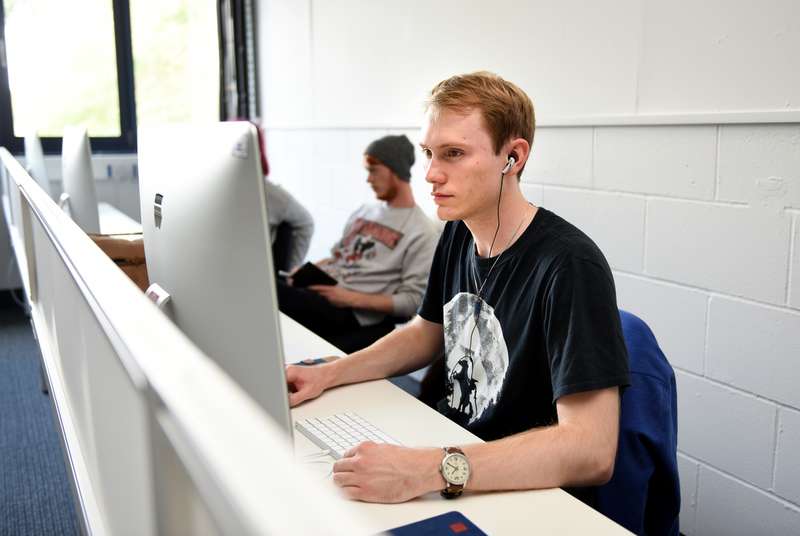 Student working on computer in the Lightroom