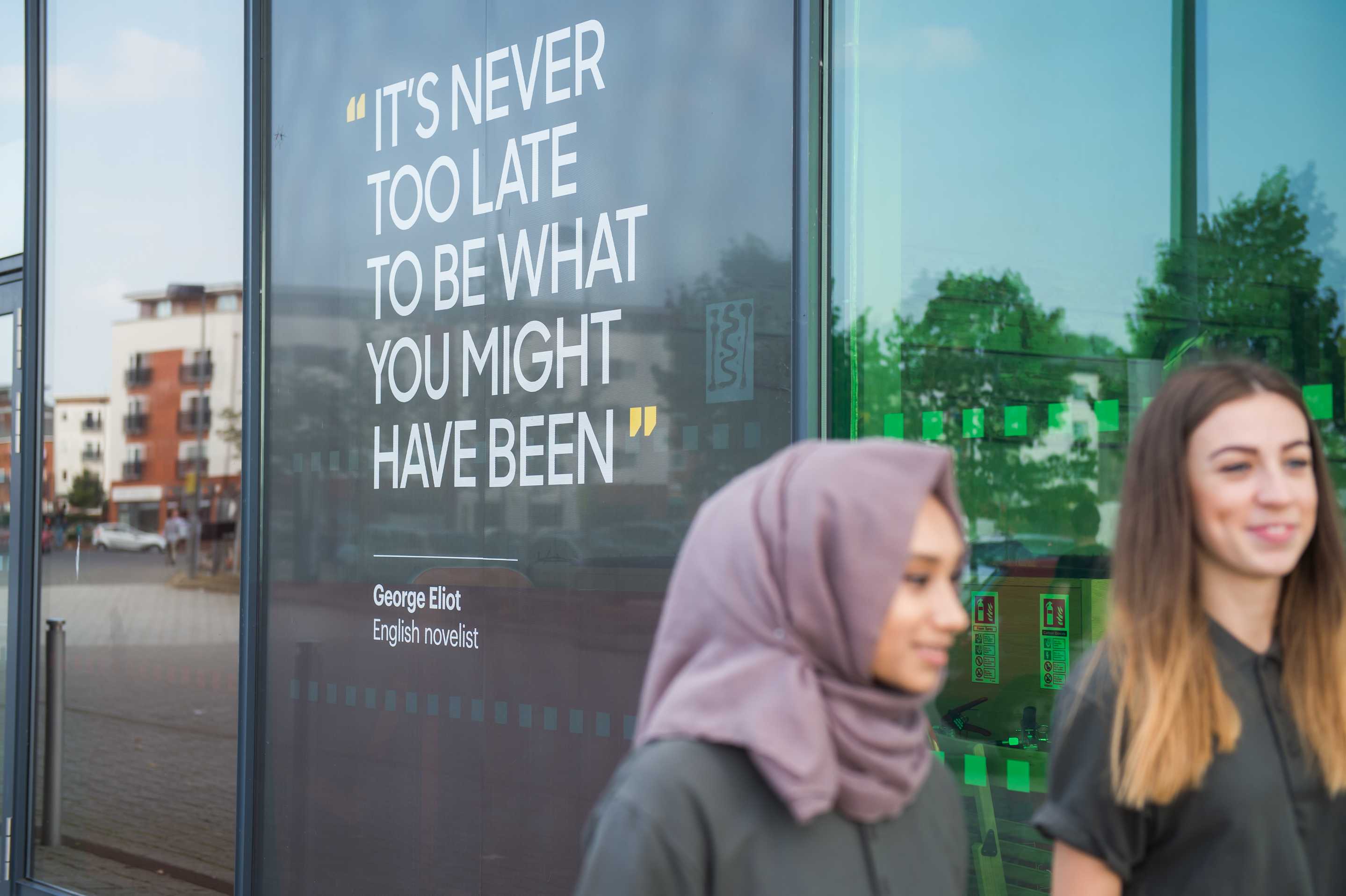 Student walking past quote on the waterfront