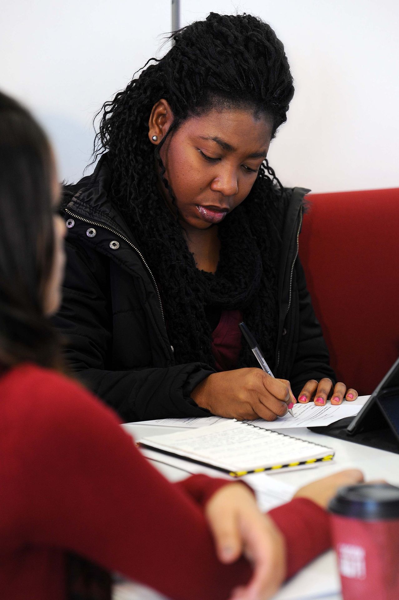 A student writing on a piece of paper