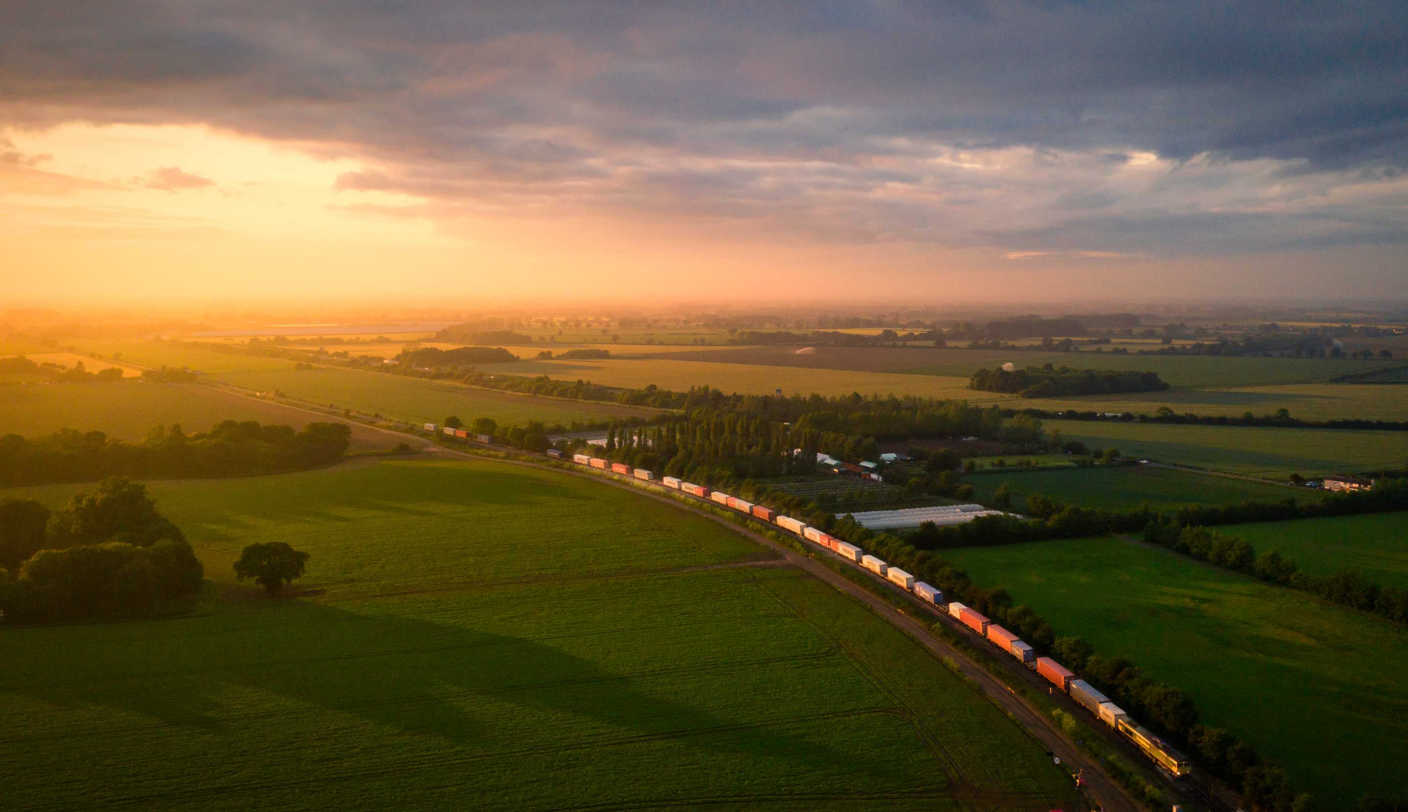 An aerial view across fields at sunset
