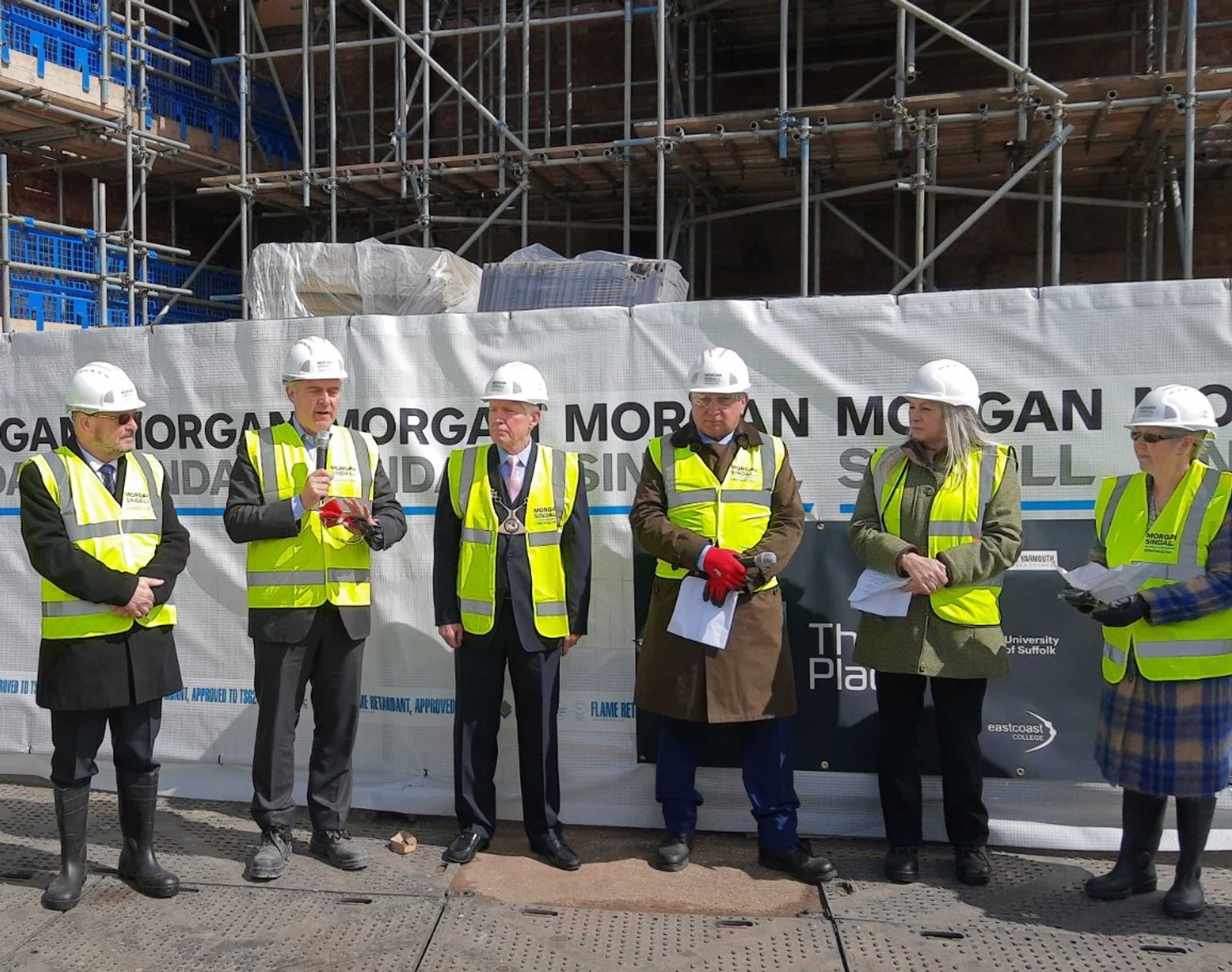 Leaders from the partners involved in The Place gather for the topping out ceremony