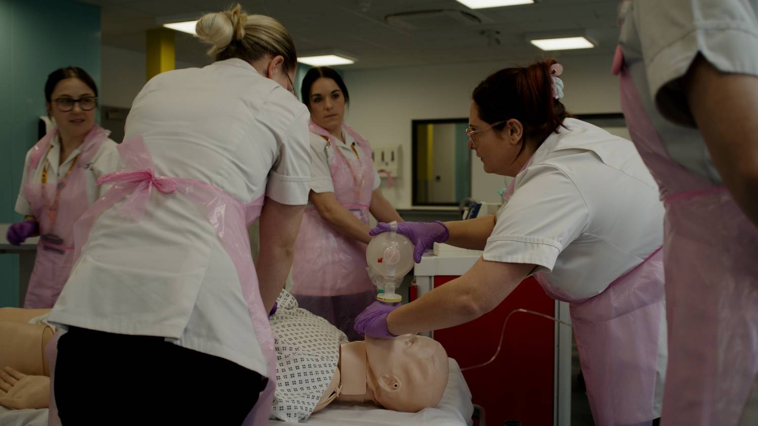 Nursing students working on a simulated patient